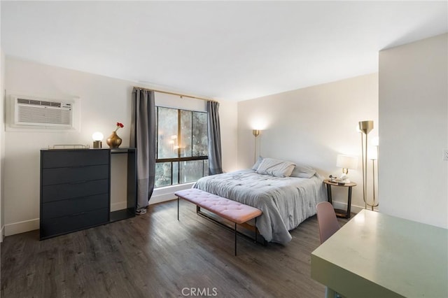 bedroom with dark wood-type flooring and a wall unit AC