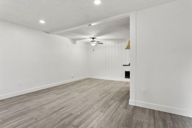 spare room featuring wood-type flooring, a textured ceiling, and ceiling fan