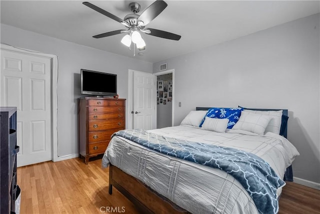 bedroom with hardwood / wood-style floors and ceiling fan