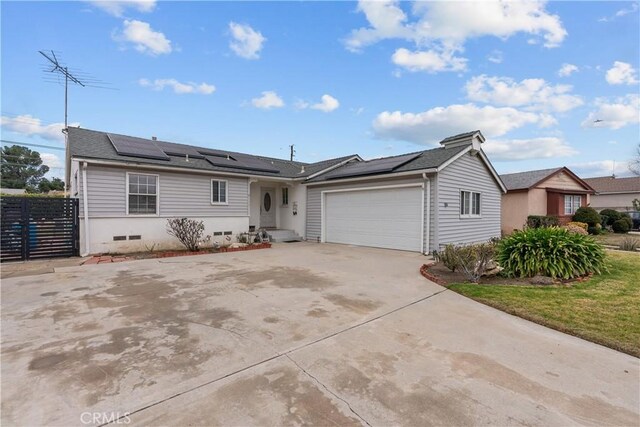 single story home featuring a garage and solar panels