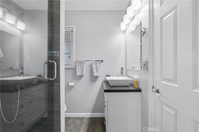 bathroom with vanity, wood-type flooring, and a shower with door