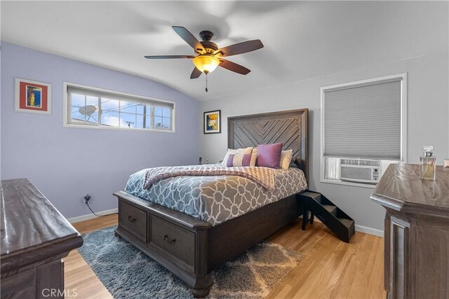 bedroom featuring ceiling fan, lofted ceiling, cooling unit, and light wood-type flooring