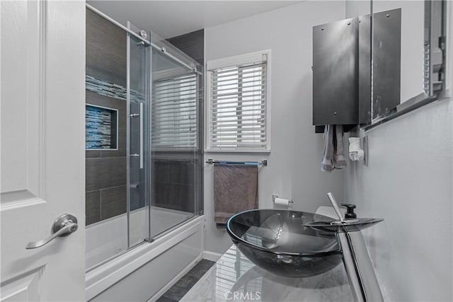 bathroom with shower / bath combination with glass door