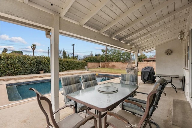 view of patio with grilling area and a fenced in pool