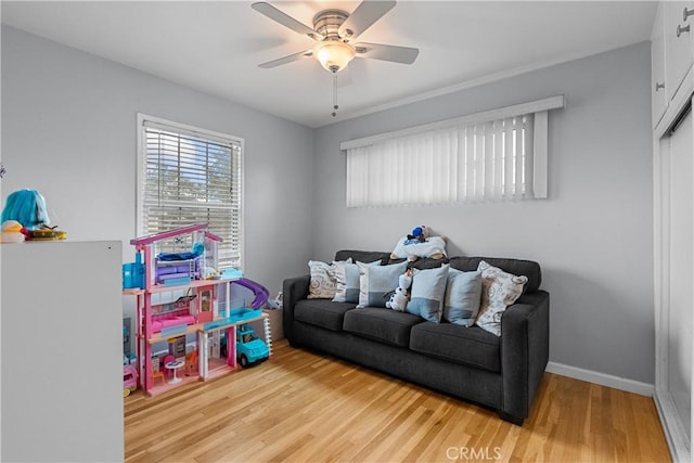 recreation room with light hardwood / wood-style flooring and ceiling fan