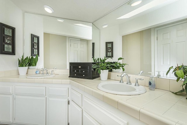 bathroom featuring vanity and a skylight