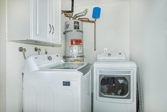 laundry area featuring cabinets, independent washer and dryer, and secured water heater