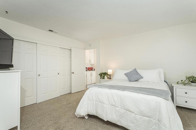 carpeted bedroom featuring a closet