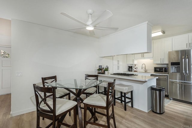 656 Westlake St, Encinitas, CA 92024 - kitchen with appliances with stainless steel finishes, a sink, light wood finished floors, a ceiling fan, and light countertops