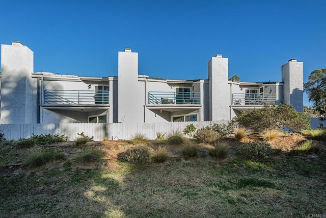 656 Westlake St, Encinitas, CA 92024 - rear view of house with a chimney and fence