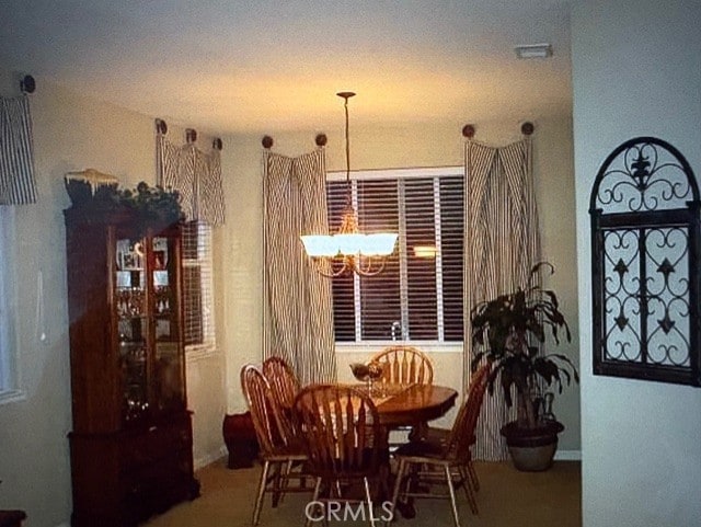 dining space with a notable chandelier