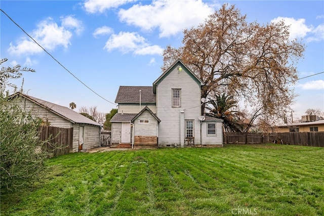 back of house with a yard