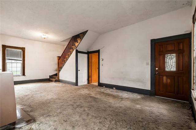 unfurnished room with dark carpet