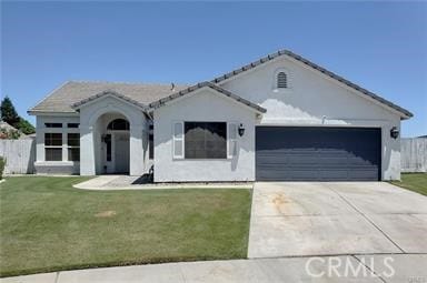 view of front of house with a garage and a front lawn