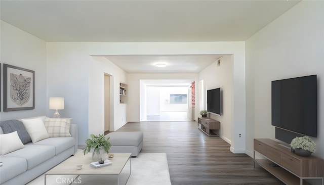 living room featuring baseboards and wood finished floors