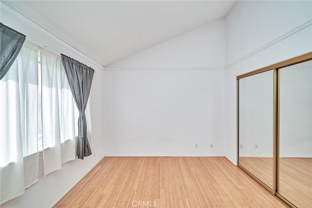 interior space featuring hardwood / wood-style flooring and lofted ceiling