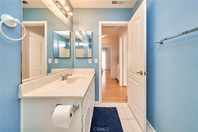 bathroom with tile patterned flooring and vanity