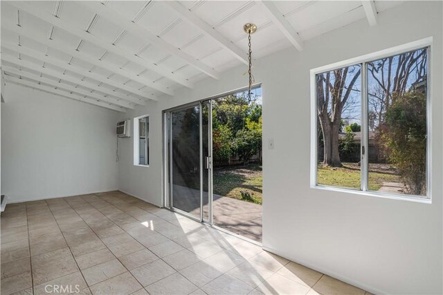 unfurnished sunroom featuring beam ceiling, a wealth of natural light, and a wall mounted AC