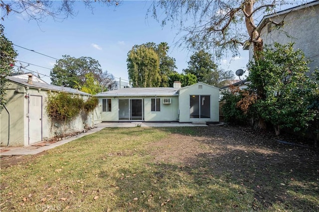 back of house with a yard and a patio area