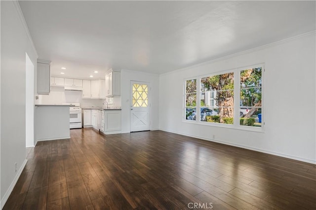 unfurnished living room featuring crown molding and dark hardwood / wood-style floors