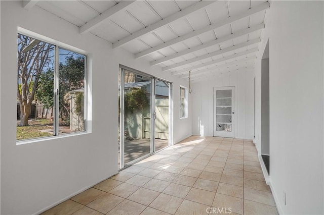 unfurnished sunroom featuring lofted ceiling with beams and wooden ceiling