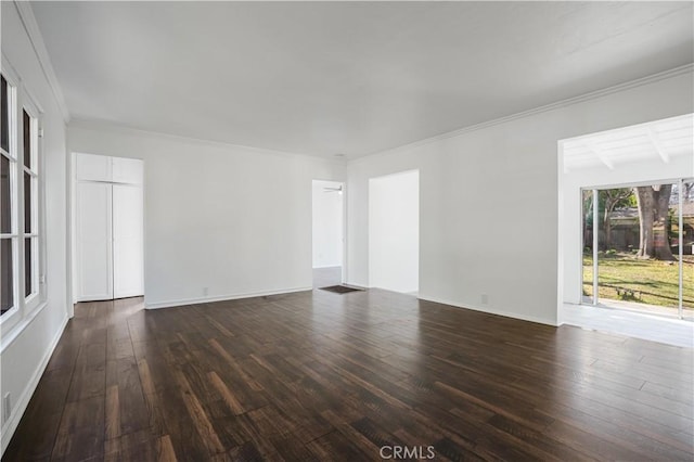 unfurnished room with ornamental molding and dark hardwood / wood-style floors