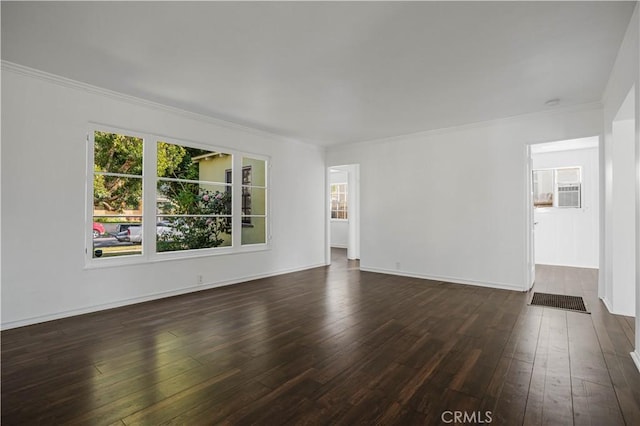 unfurnished living room with crown molding and dark wood-type flooring