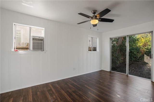 unfurnished room featuring ceiling fan, cooling unit, and dark hardwood / wood-style flooring