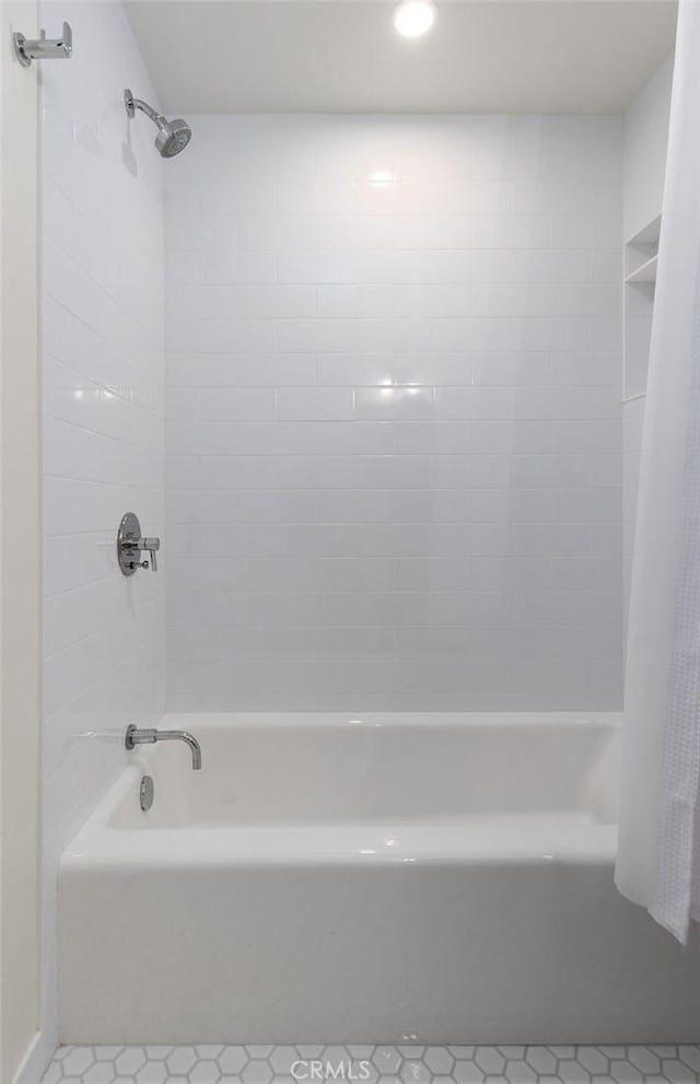 bathroom with shower / tub combo and tile patterned flooring