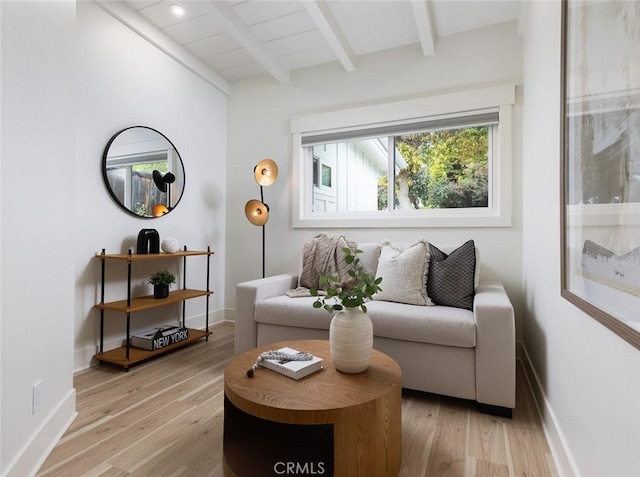 living room featuring light wood-type flooring and beam ceiling