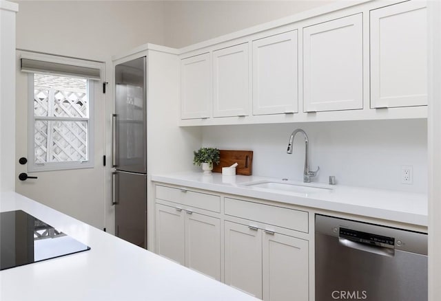 kitchen with white cabinetry, sink, and stainless steel appliances