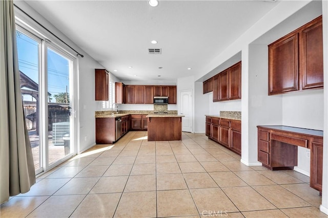 kitchen featuring light tile patterned floors, visible vents, stainless steel dishwasher, a kitchen island, and black microwave