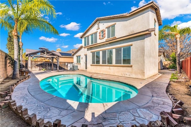 back of property featuring a fenced backyard, central AC, a gazebo, a fenced in pool, and stucco siding