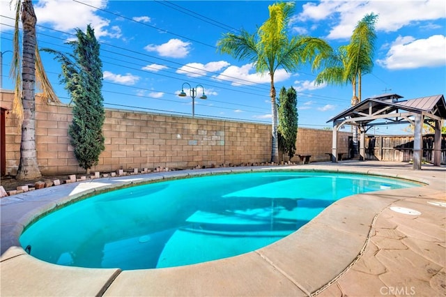 view of swimming pool featuring a fenced in pool, a fenced backyard, and a gazebo