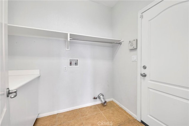 washroom featuring laundry area, hookup for a washing machine, baseboards, and light tile patterned floors