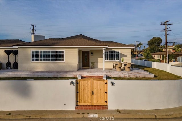 view of front of house featuring a fenced front yard and a gate