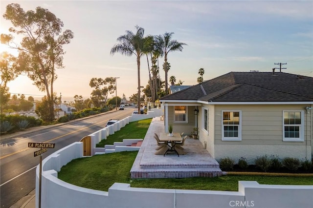 exterior space featuring a yard, a patio, and fence