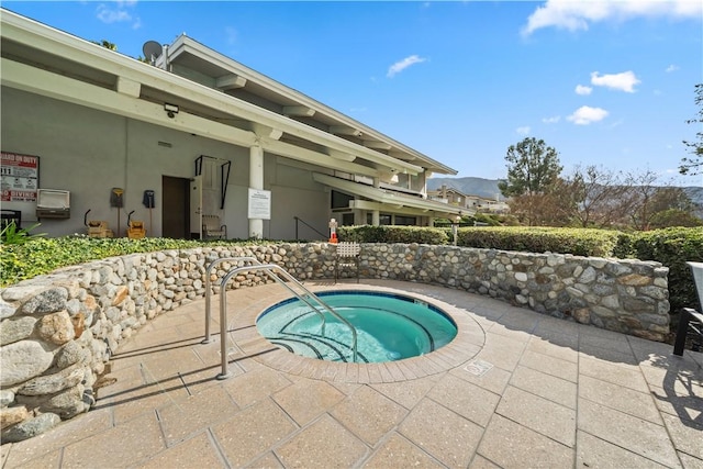 view of swimming pool featuring a patio area and a community hot tub