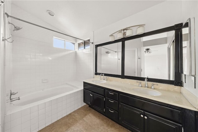 bathroom featuring tile patterned floors, a sink, tiled shower / bath, and double vanity