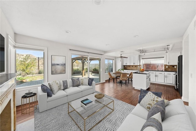 living area featuring wood finished floors and baseboards