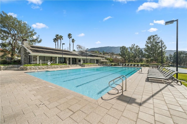 community pool featuring a patio area and a mountain view