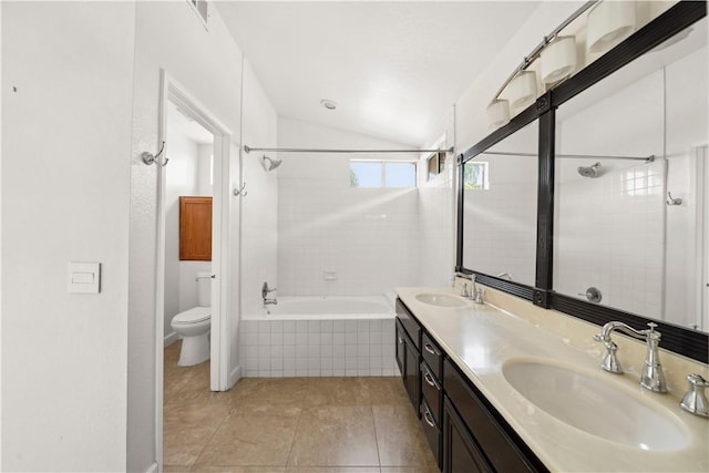 full bath featuring toilet, double vanity, vaulted ceiling, and a sink