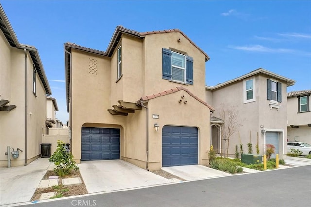 mediterranean / spanish-style house with a garage