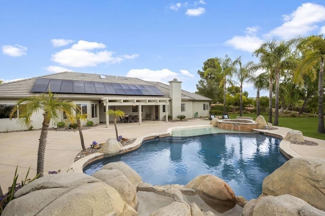 view of pool featuring a pool with connected hot tub and a patio