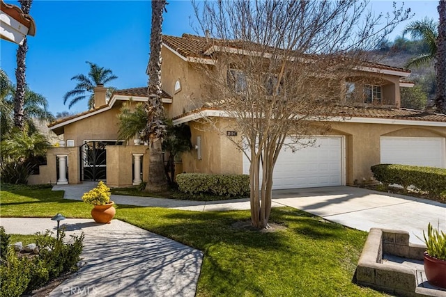 mediterranean / spanish-style home with a garage, driveway, stucco siding, a tiled roof, and a front yard