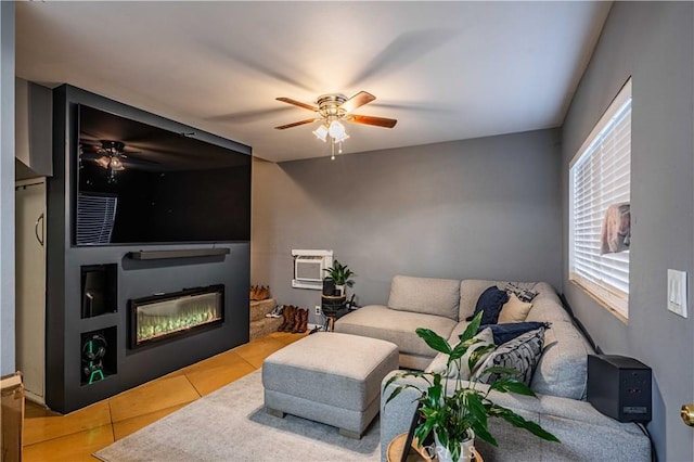 tiled living room featuring an AC wall unit and ceiling fan