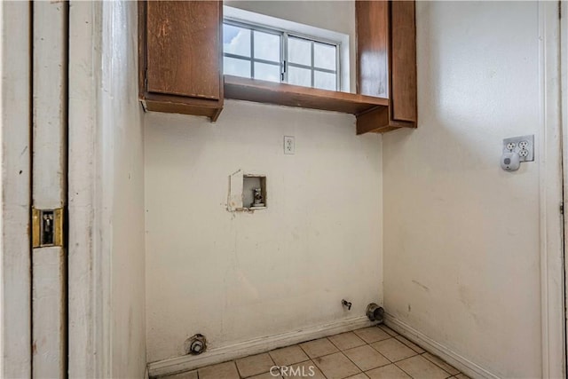 washroom featuring washer hookup, hookup for an electric dryer, cabinets, and light tile patterned flooring