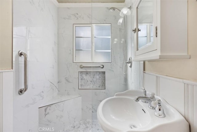 bathroom featuring sink and a tile shower