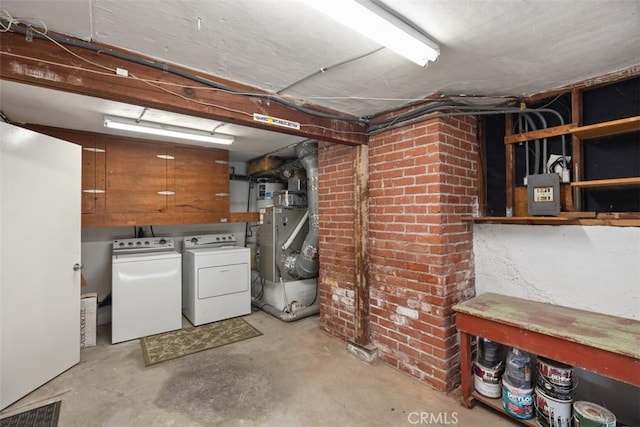 basement featuring washer and dryer and heating unit