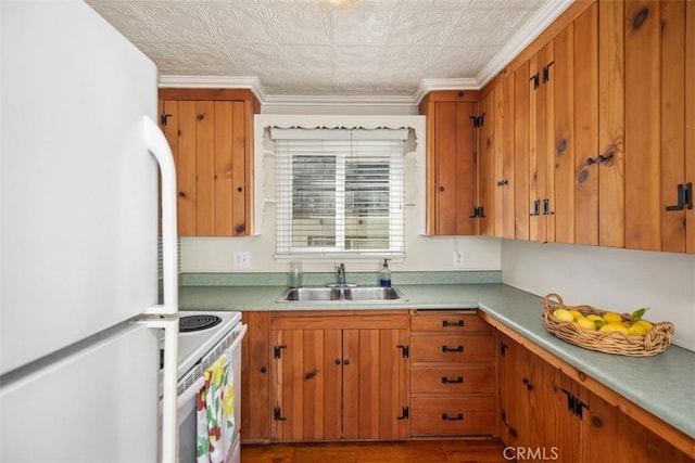 kitchen with crown molding, white appliances, and sink